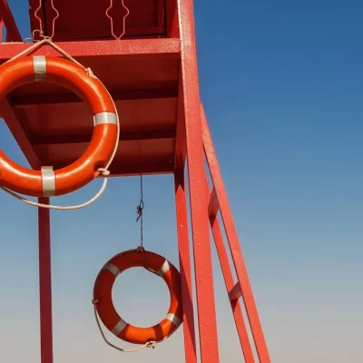 red-rescue-tower-with-lifeline-against-blue-sky red-rescue-tower-with-lifeline-against-blue-sky